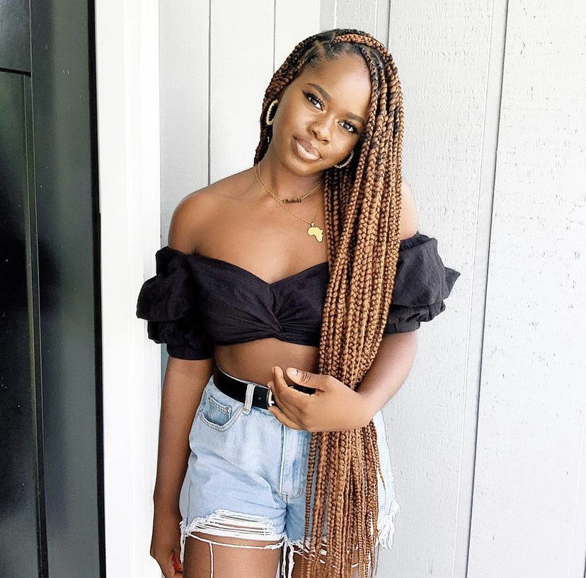 Black woman wearing long brown box braids | protective styles for natural hair | All Things Savvy